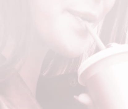 Lady drinking through a straw